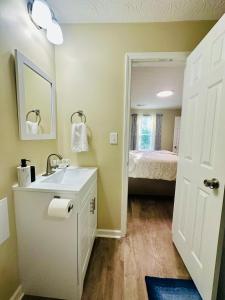 a bathroom with a sink and a bedroom with a bed at Home in Bourbon Country in Bardstown