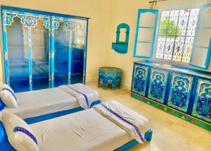 a bedroom with two beds and a window at à 5 minutes de Seguia Beach résidence in Midoun +3 photos