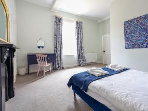 a bedroom with a bed and a chair and a window at Salt House - Uk43012 in Berkeley +17 photos
