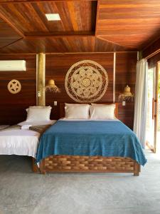 a bedroom with two beds with wooden walls at Villa Caravelas Praia de Moitas in Amontada +67 photos