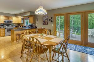 a kitchen and dining room with a wooden table and chairs at 2 Mi to Woodbury Wildlife Area Cozy Farmhouse! in Warsaw