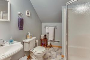 a bathroom with a toilet and a sink and a shower at 2 Mi to Woodbury Wildlife Area Cozy Farmhouse! in Warsaw +25 photos