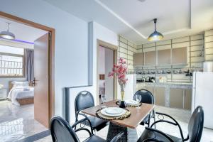 a kitchen and dining room with a table and chairs at White Majorelle Duna Blanca in Tamraght Ouzdar