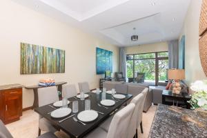 a dining room with a table and chairs at Pristine Bay 1002 home in Roatan