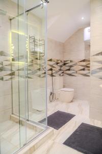 a bathroom with a glass shower and a toilet at Ground Floor Gem - Patio Lounge in Cairo +21 photos