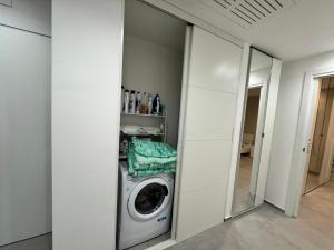 a washing machine in a room with a mirror at Sul Mare in Molfetta