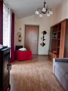 a living room with a red table and a couch at Casa Rosy Sicilia in Brolo