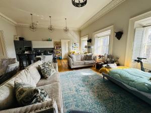 a living room with a couch and a table at Bernard Street Edinburgh Apartment in Edinburgh