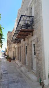 a brick building with a fire escape on the side of it at Charistella Apartment in Symi