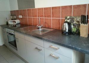 a kitchen with a sink and a counter top at Ferienwohnung am Nürburgring 2.OG in Adenau