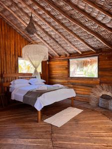 a bedroom with a bed in a wooden cabin at Rancho do Buna in Atins +96 photos