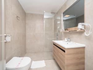 a bathroom with a toilet and a sink at CASA AL MARE RESIDENCE in Bečići