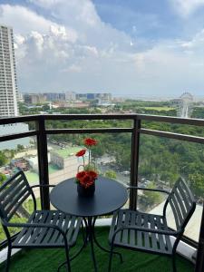 a table and two chairs on a balcony with a view at Modern Pet Friendly 1br Condo with Balcony near AIRPORT MOA & OKADA Pasay Staycation WFH ready Free Pool Acces Gym and Sauna in Manila