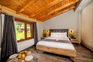a bedroom with a large bed and a window at Ayder Palazzo Hotel in Ayder Yaylasi
