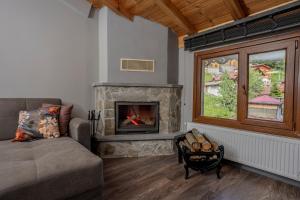 a living room with a couch and a fireplace at Ayder Palazzo Hotel in Ayder Yaylasi +193 photos