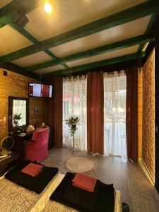 a living room with two beds and a desk at Smestaj sa bazenom Sunny Hill in Smederevska Palanka