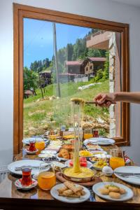 a table full of food and orange juice at Ayder Palazzo Hotel in Ayder Yaylasi