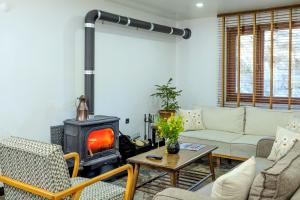 a living room with a couch and a wood stove at Ayder Palazzo Hotel in Ayder Yaylasi