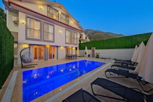 a swimming pool in the backyard of a house at Yaz Villa in Fethiye