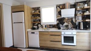 a kitchen with a white stove and a window at Yaz Villa in Fethiye