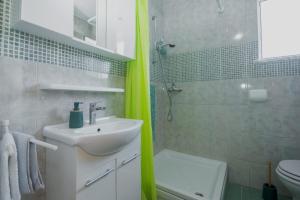 a bathroom with a sink and a toilet and a shower at Apartment Kamenar 3 in Klimno +28 photos