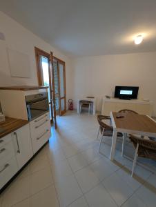 a kitchen and dining room with a table and a dining room at 73059 Versilia in Fontanelle
