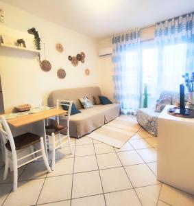 a living room with a couch and a table at Sky & Sand Apartment in Porto Santa Margherita di Caorle