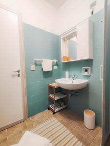 a bathroom with a sink and a mirror at Sky & Sand Apartment in Porto Santa Margherita di Caorle