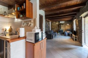 a kitchen with a microwave on top of a counter at Vila Deja in Marušići