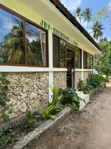 a building with a sign on the side of it at JozaniBiospherevillage in Jozani