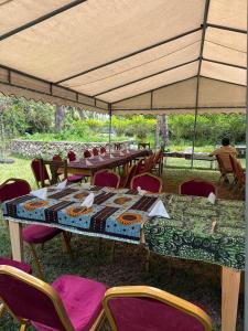 a group of tables and chairs under a tent at JozaniBiospherevillage in Jozani