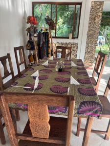a dining room table with a table cloth on it at JozaniBiospherevillage in Jozani