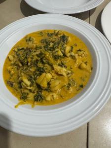 a white bowl of food on a white plate at JozaniBiospherevillage in Jozani