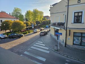 a street with cars parked next to a building at Old Town View in Rzeszów