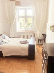 a bedroom with a large bed and a window at Old Town View in Rzeszów
