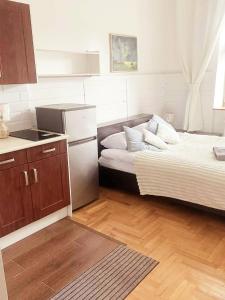 a small kitchen with two beds and a refrigerator at Old Town View in Rzeszów