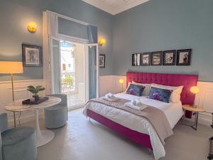 a bedroom with a large bed with a red headboard at Luxury Suite - Free WifI - Smart Tv - centro Storico in Mesagne