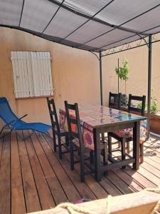 a table and chairs sitting on a deck with a table and chairs at cottage LES SENS CIEL in Saint-Martin