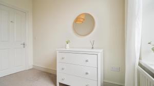 a white dresser with a mirror on a wall at Crookes Gem with Garden & Alpacas Nearby in Walkley