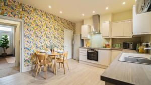 a kitchen with a table and chairs in a room at Crookes Gem with Garden & Alpacas Nearby in Walkley +42 photos