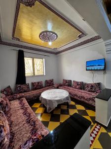 a living room with a couch and a table at TOODA House in Imsouane