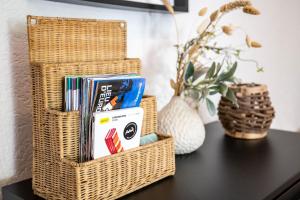 ein Korbkorb auf einem Tisch mit Büchern in der Unterkunft les Jardiniers in Straßburg