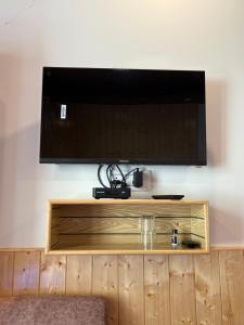 a flat screen tv on top of a wooden cabinet at Sun Beam Hotel Koksar in Khoksar