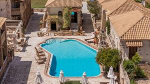 an overhead view of a swimming pool with umbrellas at Garden Village Residence in Kalamaki +2 photos
