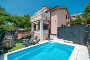 a villa with a swimming pool and a house at Villa Viktoria with private swimming pool in Donji Muć