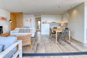 a living room with a bed and a table and a kitchen at Luxury Central Apartments, Illa Blanca, Calella in Calella de Palafrugell