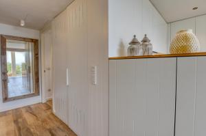 a hallway with white walls and vases on a shelf at Luxury Central Apartments, Illa Blanca, Calella in Calella de Palafrugell