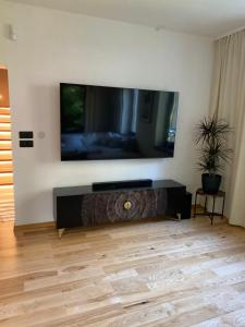 a living room with a large flat screen tv on a wall at Dream House - Vysoké Tatry in Vysoké Tatry