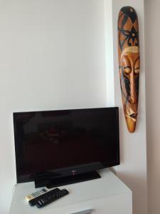 a flat screen tv sitting on top of a white table at Flat Lora Pomorie in Pomorie