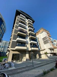 a tall apartment building next to a building at RUBİN Residence in Alanya